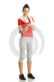 Young fitness woman holding bottle of water