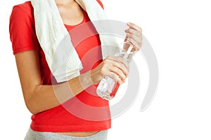 Young fitness woman holding bottle of water