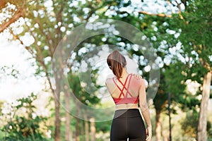 Young fitness woman holding her sports injury shoulder and neck, muscle painful during training. Asian runner female having body