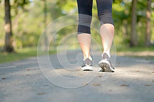 Young fitness woman legs walking in the park outdoor, female runner running on the road outside, asian athlete jogging and exercis