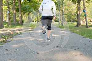 Young fitness woman legs walking in the park outdoor, female runner running on the road outside, asian athlete jogging and exercis