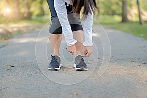 Young fitness woman legs walking in the park outdoor, female runner running on the road outside, asian athlete jogging and exercis