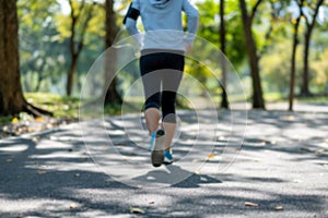 Young fitness woman legs walking in the park outdoor, female runner running on the road outside, asian athlete jogging and exercis