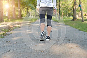 Young fitness woman legs walking in the park outdoor, female runner running on the road outside, asian athlete jogging and exercis