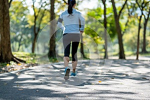 Young fitness woman legs walking in the park outdoor, female runner running on the road outside, asian athlete jogging and exercis