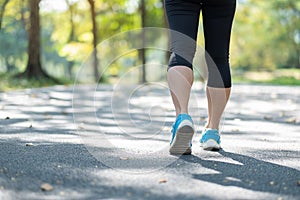 Young fitness woman legs walking in the park outdoor, female runner running on the road outside, asian athlete jogging and exercis