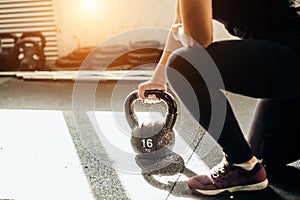 Woman standing on knee and preparing for cross fit exercise