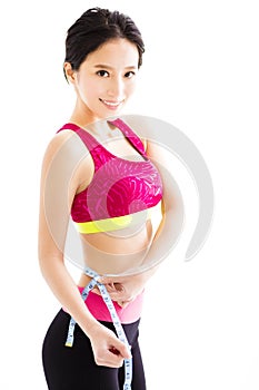 Young Fitness woman measuring her belly