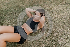 Young fitness woman practice morning workout exercises outdoor. Fitness and sport lifestyle concept