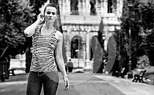 Young fitness woman in Rome, Italy and listening to music