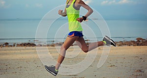 young fitness woman running at morning beach