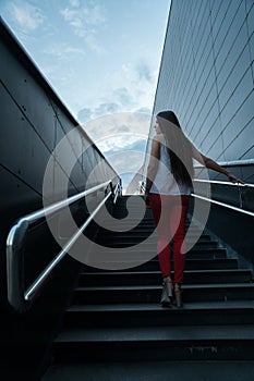Young fitness woman running on mountain stairs