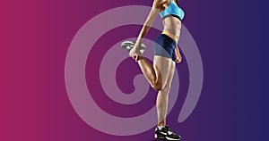 Young fitness woman stretching legs. Isolated photo