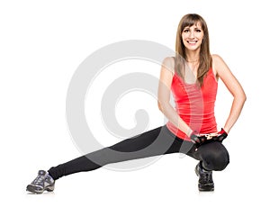 Young fitness woman stretching legs