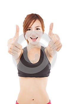 Young fitness woman with thumbs up