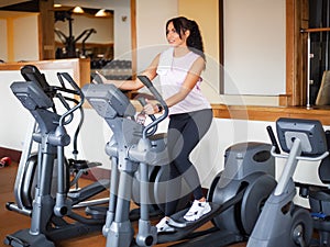 Young fitness woman working out in the gym. Woman working out on exercise bike