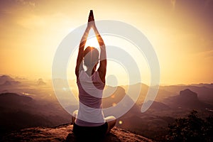 woman meditating on sunrise mountain peak