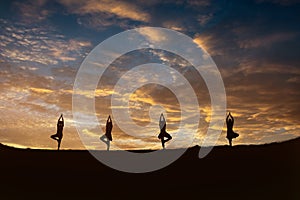 Young fitness yoga woman meditating on sunrise mountain