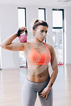 Young fitnesswoman training with a kettle