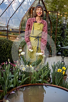 Young florist in beautiful garden