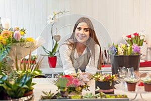 Young florist woman in a flower shop