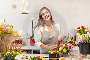 Young florist woman in a flower shop