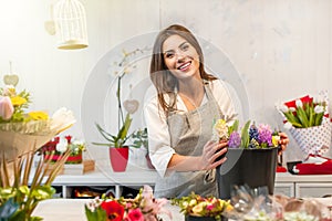 Young florist woman in a flower shop