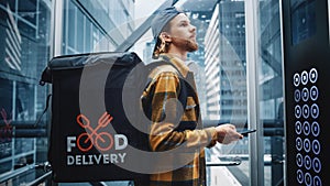 Young Food Delivery Person Riding Glass Elevator in Modern Office Building. Restaurant Delivery Co