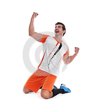 Young football player celebrating scoring of goal on white