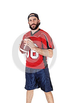 Young football player standing with his football in his hand