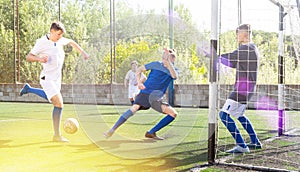 Young football players fighting for ball