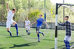 Young football players fighting for ball