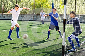 Young football players fighting for ball