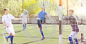 Young football players fighting for ball