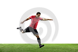 Young football, soccer player of team in action, motion isolated on white background. Concept of sport, movement, energy