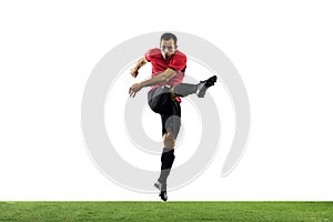 Young football, soccer player of team in action, motion isolated on white background. Concept of sport, movement, energy