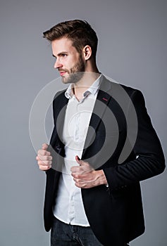 Young and free. confident businessman in shirt and jacket. boss male. sexy ceo on gray background. modern office life