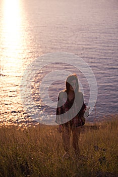 Young freedom woman enjoy ocean sunset on mountain peak