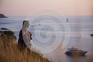 Young freedom woman enjoy ocean sunset on mountain peak