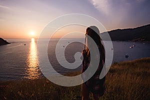 Young freedom woman enjoy ocean sunset on mountain peak