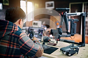 Young freelancer man editing video on laptop