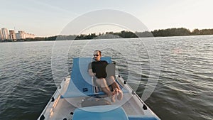 Young freelancer works on the computer on a boat. Remote Business. passive earnings