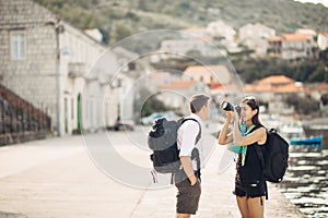 Young freelancing photographers enjoying traveling and backpacking.Photojournalism.Documentary travel photos.Lightweight travel