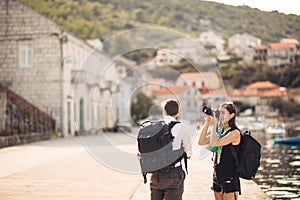 Young freelancing photographers enjoying traveling and backpacking.Photojournalism.Documentary travel photos.Lightweight travel