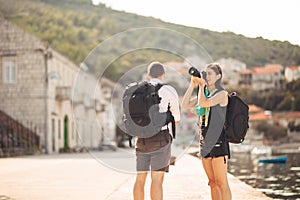 Young freelancing photographers enjoying traveling and backpacking.Photojournalism.Documentary travel photos.Lightweight travel