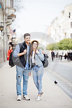 Young freelancing photographers enjoying traveling and backpacking. Young couple with backpack travel new destination