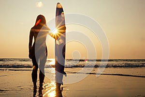 Young freelancing woman in a wetsuit swimming over surfboard in the water at beach.surfer girl relaxing in paradise