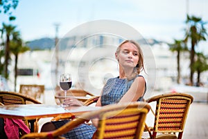 Young French woman drinking red wine