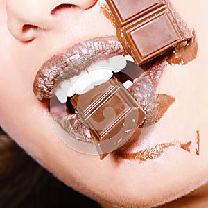 Young fresh beautiful woman eating chocolate