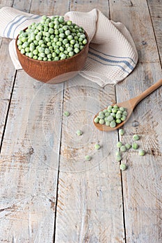 Young fresh green peas on wooden table viewed from above. Green pea pod table peas. Closeup of fresh green peas Pisum sativum